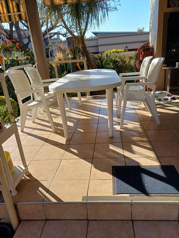 Plastic patio table plus four chairs