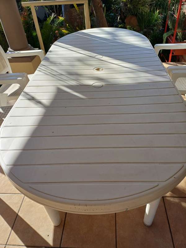 Plastic patio table plus four chairs