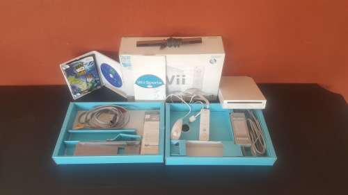 Nintendo Wii with two games, sensor bar, Wii controller and nunchuk and stand for Wii