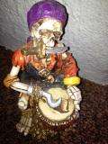 CERAMIC FIGURINE SKULL WITH DRUM AND HOOK