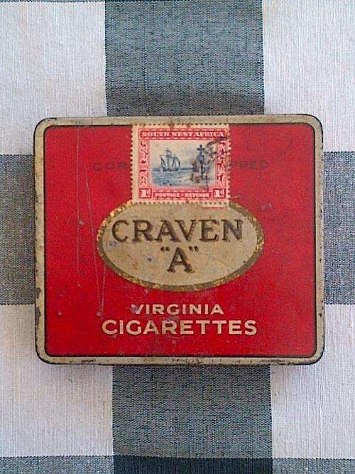 CIGARETTE TIN WITH VINTAGE STAMP: Craven A 20's with 1d very old SWA stamp sticked on it!