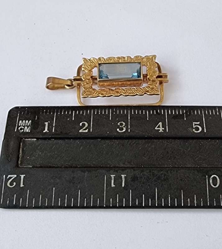 `ELECTRICK BLUE TOPAZ`  Set in a 9CT Yellow Gold Pendant (Genuine Gold)
