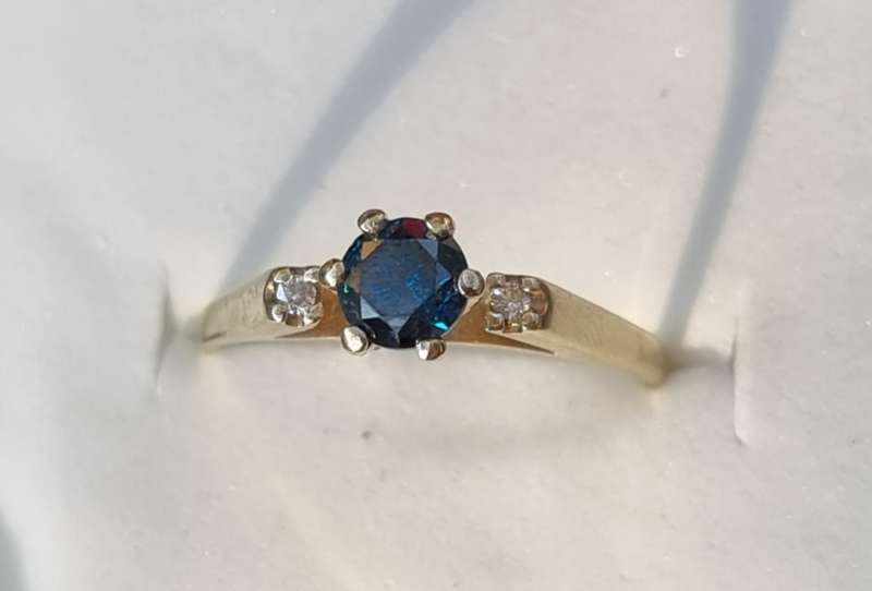 0.56 carat certified fancy green diamond engagement ring set in 9ct yellow gold