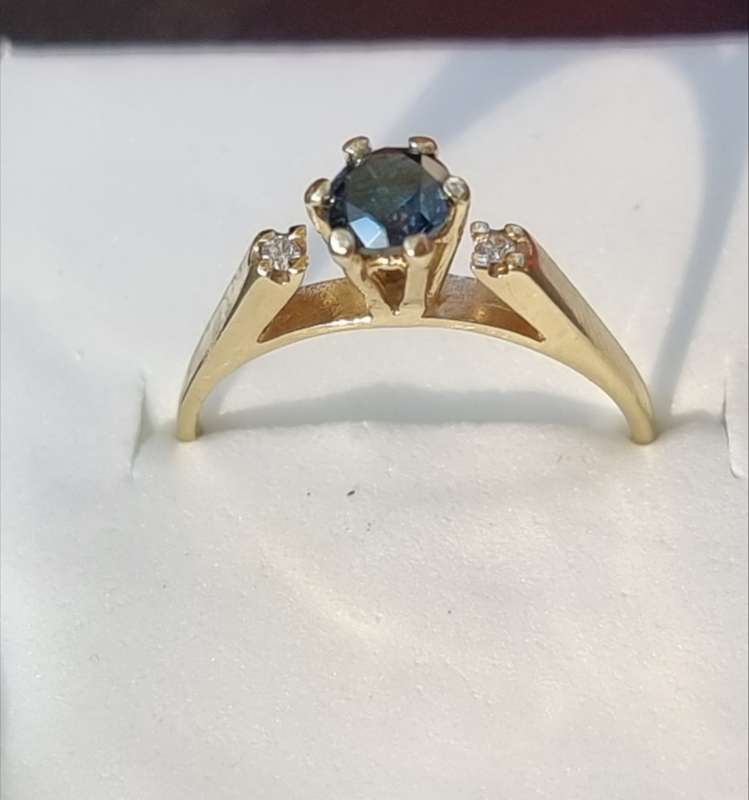 0.56 carat certified fancy green diamond engagement ring set in 9ct yellow gold