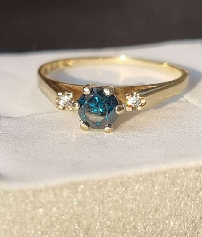 0.56 carat certified fancy green diamond engagement ring set in 9ct yellow gold
