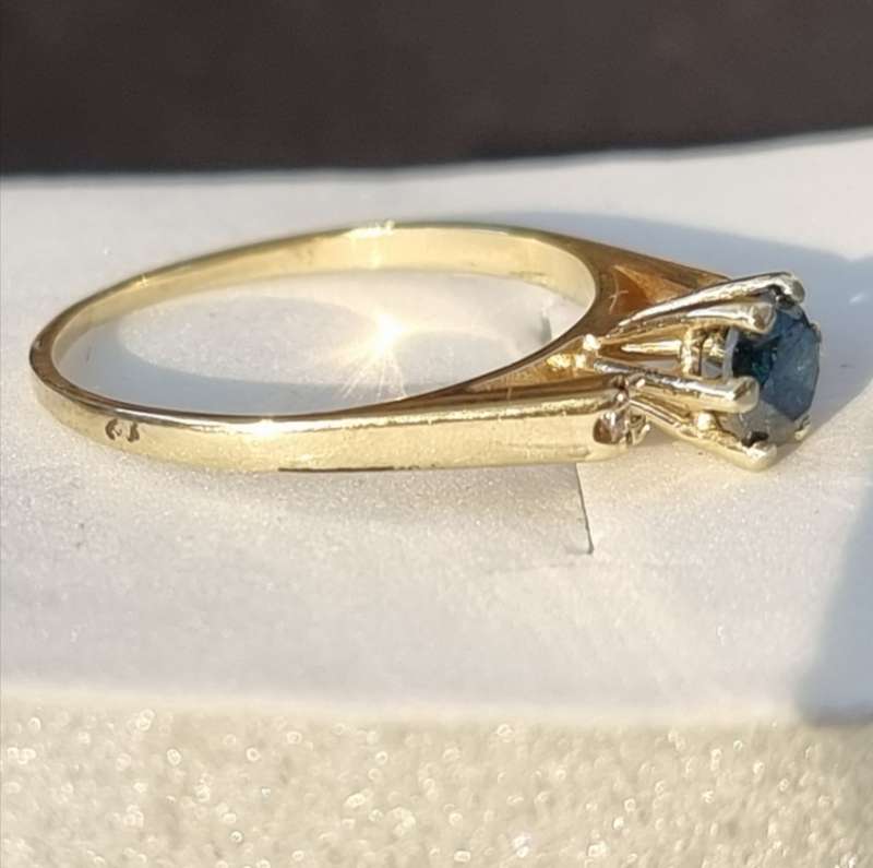 0.56 carat certified fancy green diamond engagement ring set in 9ct yellow gold