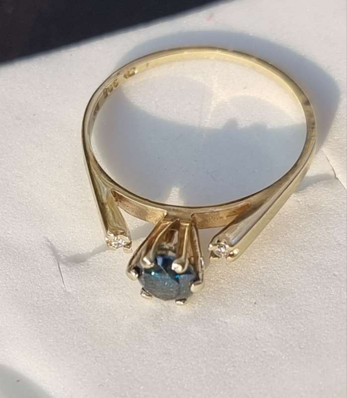 0.56 carat certified fancy green diamond engagement ring set in 9ct yellow gold