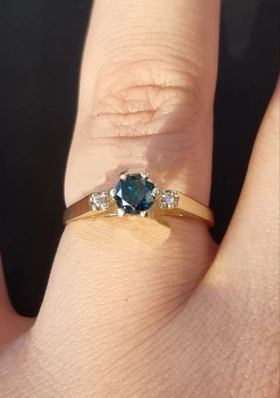 0.56 carat certified fancy green diamond engagement ring set in 9ct yellow gold