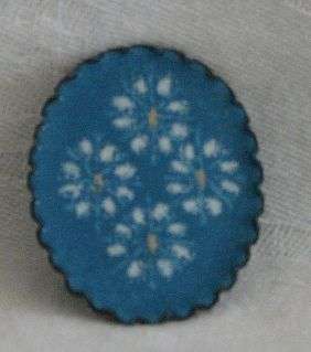 R1.00 START - Enamel Brooch - Oval in shape with a blue & white flower motiff