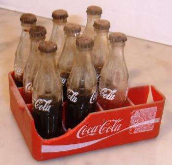 Retro Minature coca cola crate, glass bottles/metal caps.Approx.10cmL x 3cmH