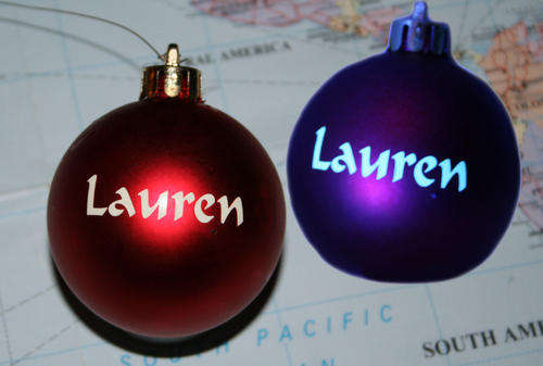 GLOW IN THE DARK names on Christmas baubles. Keeps glowing on and on and on