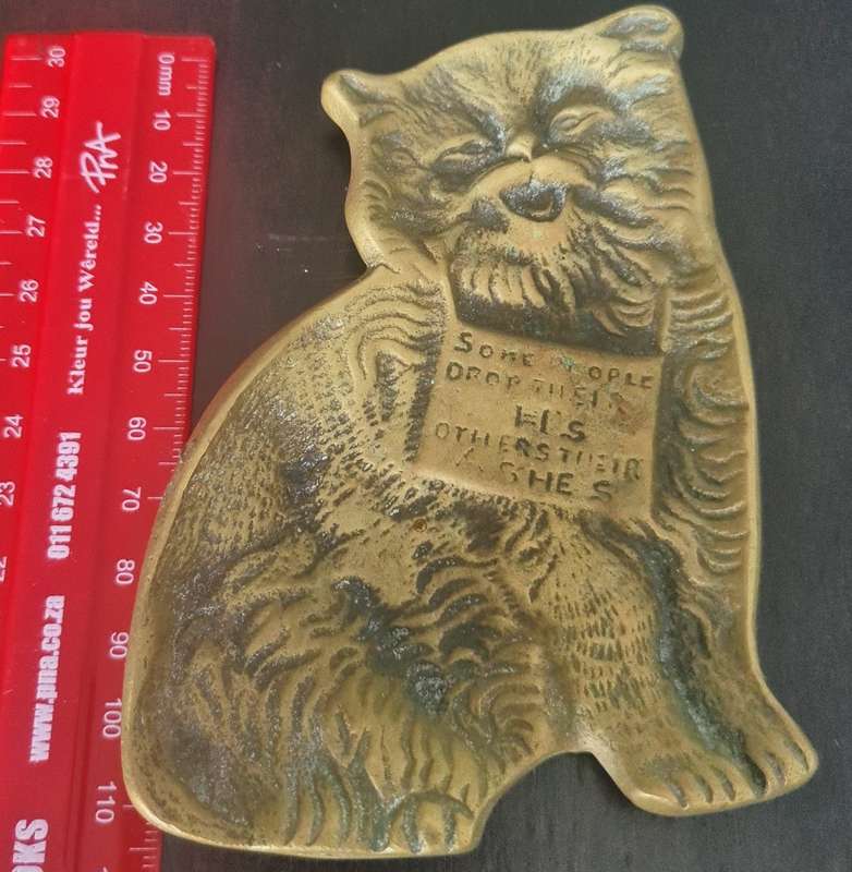 A lovely vintage brass flat cat ashtray with and embellished sign `Some people drop their H`s others