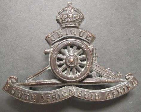SOUTH AFRICA ARTILLERY CAP BADGE WITH TURNING WHEEL - LUGS INTACT