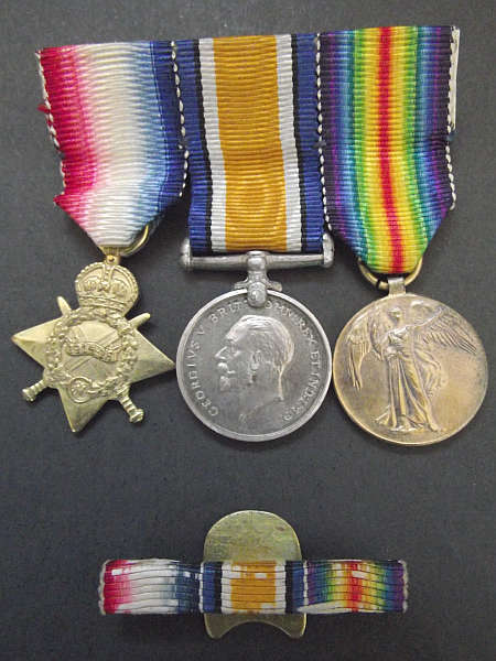 WORLD WAR ONE MINIATURE MEDAL TRIO WITH RIBBON BAR LAPEL