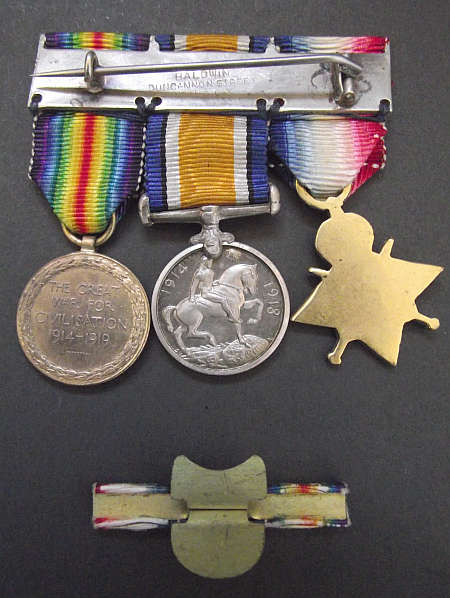 WORLD WAR ONE MINIATURE MEDAL TRIO WITH RIBBON BAR LAPEL