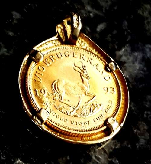 1/ 10 th KRUGERRAND SET IN  A 9 CT PENDANT  WITH A DIAMOND