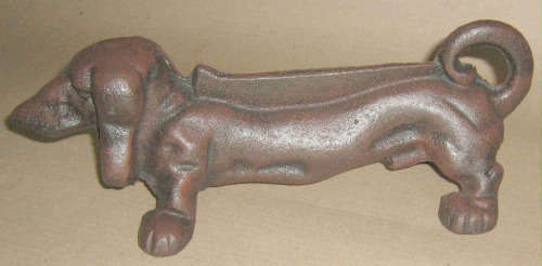 Garden. Cast iron brown sausage dog foot scraper / door stop