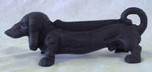 Cast iron sausage dog foot scraper / door stop