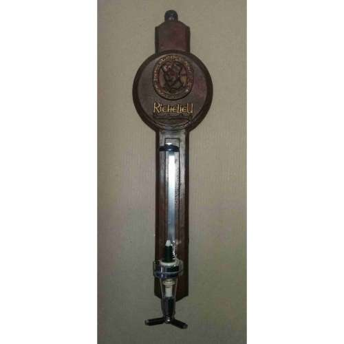 Single optic spirit tot measure dispenser on Richelieu backing. Wall hanging.
