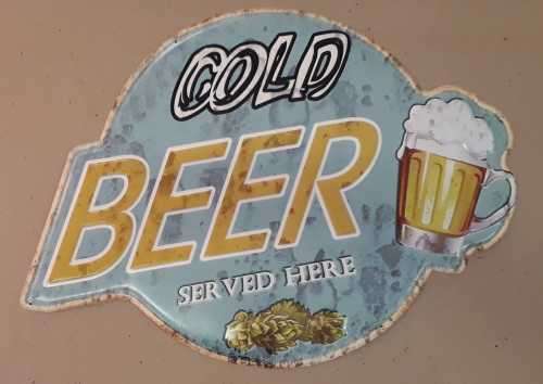 Cold beer served here, embossed metal sign