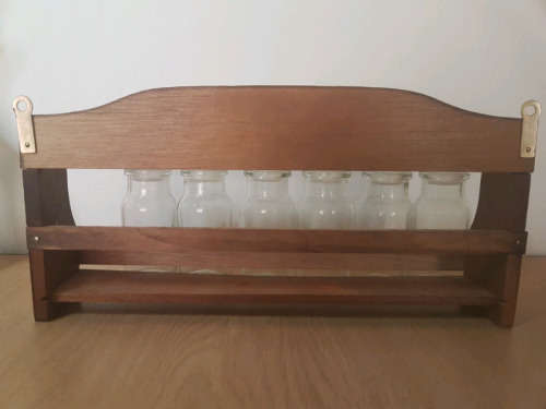 Spice rack with glass bottles