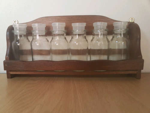 Spice rack with glass bottles