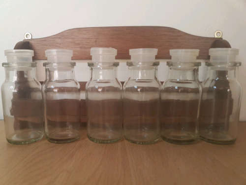 Spice rack with glass bottles