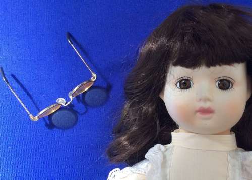 Vintage Porcelain Doll with Glasses