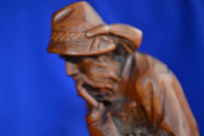 Wooden Carving of a Hunter with his Dog