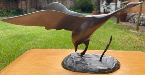 DESK TOP SIZE BRONZE SCULPTURE, BIRD TAKING OFF FROM GROUND BY UNKNOWN ARTIST