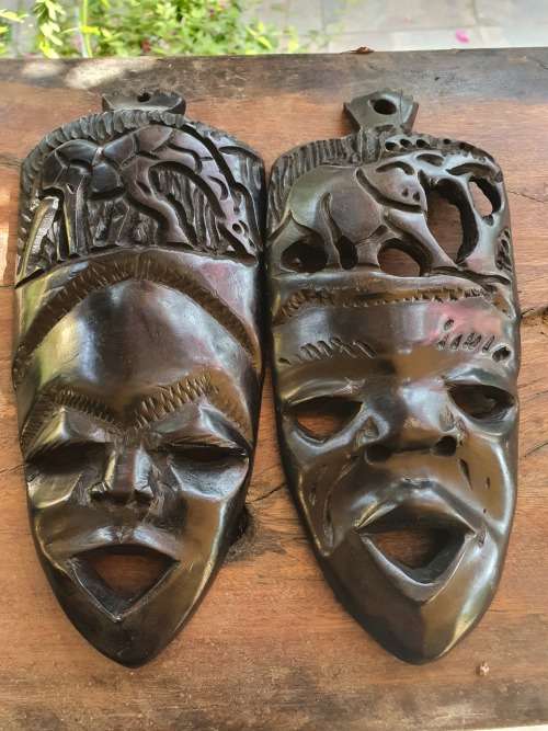 A PAIR OF EBONTY??? WOOD CARVED SMALL MASKS WITH FACE, GIRAFFE AND ELEPHANT