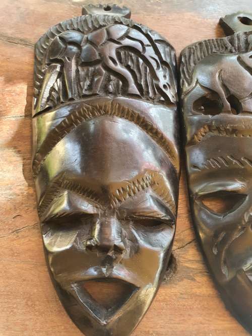A PAIR OF EBONTY??? WOOD CARVED SMALL MASKS WITH FACE, GIRAFFE AND ELEPHANT