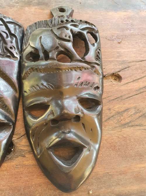 A PAIR OF EBONTY??? WOOD CARVED SMALL MASKS WITH FACE, GIRAFFE AND ELEPHANT