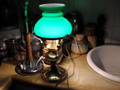MY GUESS IS THIS IS ITALIAN??? GORGEOUS BRASS WITH LEAF DETAIL BASE AND GREEN STUDENT GLASS SHADE