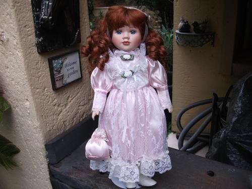 GORGEOUS REDHEAD WITH BLUE EYES. SHE'S A LOOKER PORCELAIN?? DOLL ON STAND