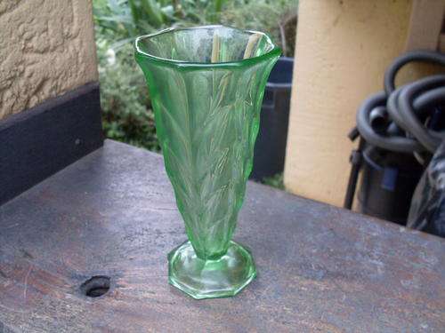 BELIEVE IT TO BE A DECO PIECE. GREEN GLASS VASE WITH DART TYPE OF PATTERN