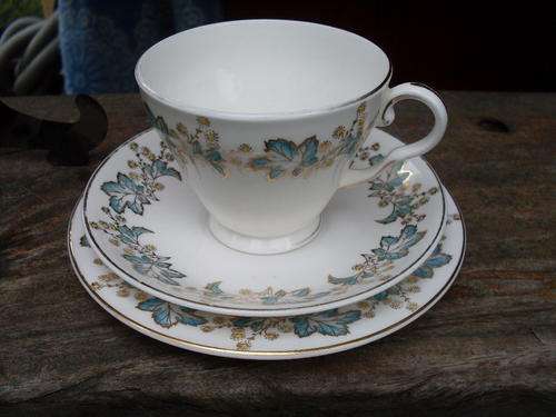ROYAL GRAFTON FINE BONE CHINA TEA TRIO GILT FLORAL + GILT SURROUND ON BLUE LEAF
