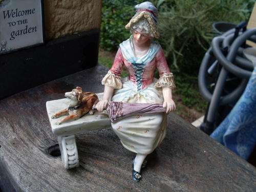 THINK POSSIBLY ITALIAN. IMPRESSED NUMBERED FIGURINE OF A VICTORIAN? MAIDEN OR LADY SEATED WITH DOG