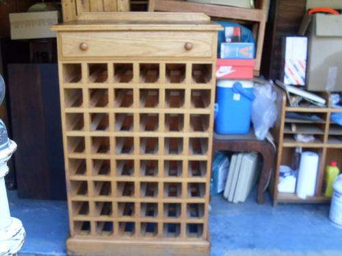 LOOKS VINTAGE. HERE WE PRESENT AN OAK WOOD 48 BOTTLE WINE RACK WITH DRAWER NICE!