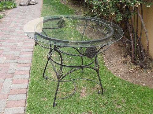 ORNATE WROUGHT IRON PATIO TABLE WITH GLASS TOP...WORTH A LOOK!