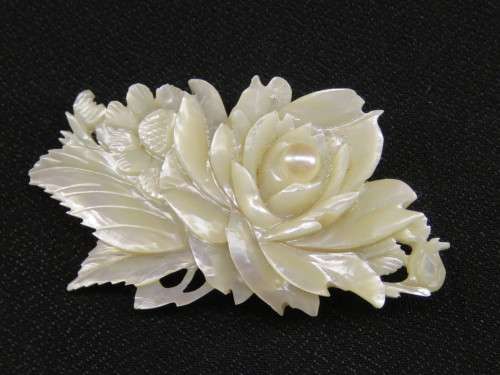 MOTHER OF PEARL CARVED BROOCH SET WITH A PEARL
