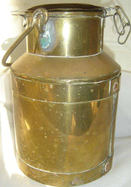 A minature brass milk can