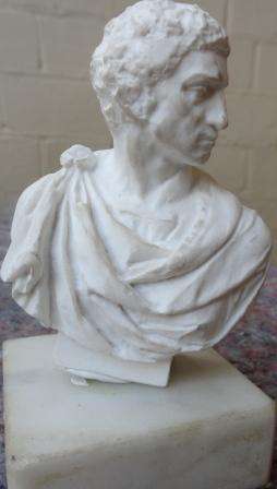 A scare minature parianware bust of Julius Caesar  on a marble base,
