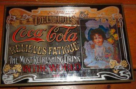A vintage Coca Cola Mirror with massive advertising.