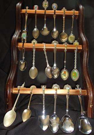 Spoon collection on aluminium and well crafted ornate wooden stand