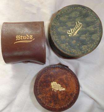 A collection of vintage leather stud boxes with some studs