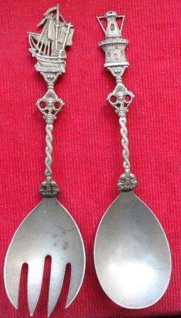 A vintage set of nickel  silver salad spoons with highly decorated stems
