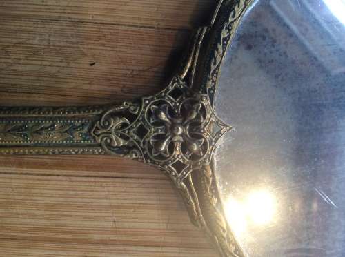 Antique brass hand mirror.