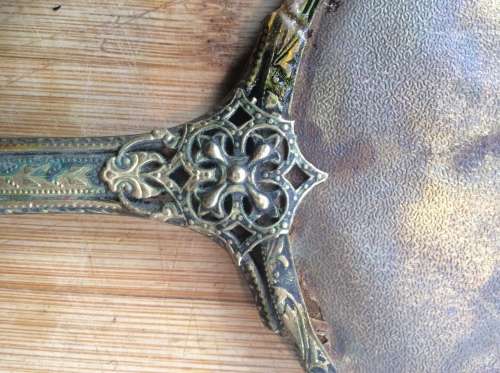 Antique brass hand mirror.