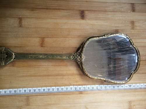 Antique brass hand mirror.